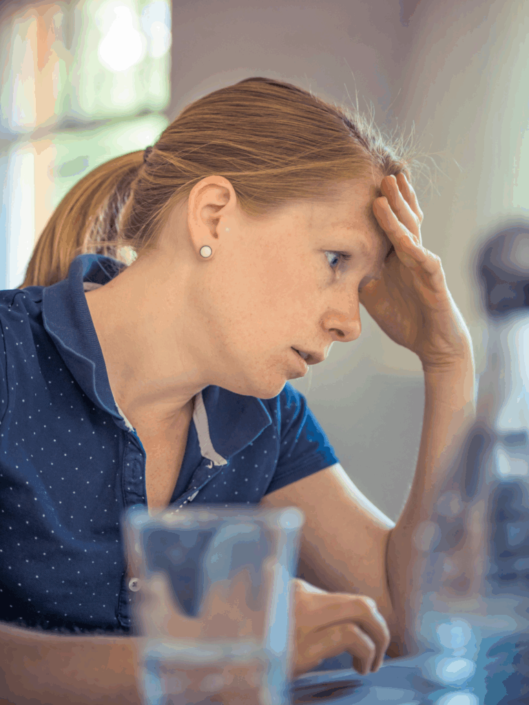 stressed women leaning her head in her hand